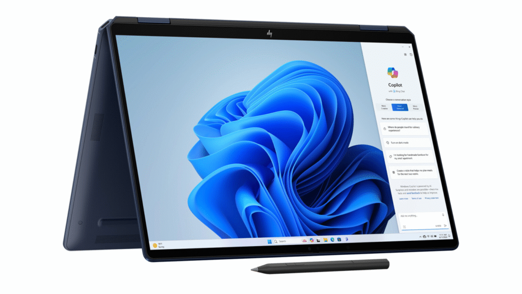 Text A dark blue HP 2-in-1 convertible laptop, likely an HP OmniBook X Flip, set in tent mode with a digital pen in the foreground, displaying the Windows 11 desktop and the Copilot AI panel.