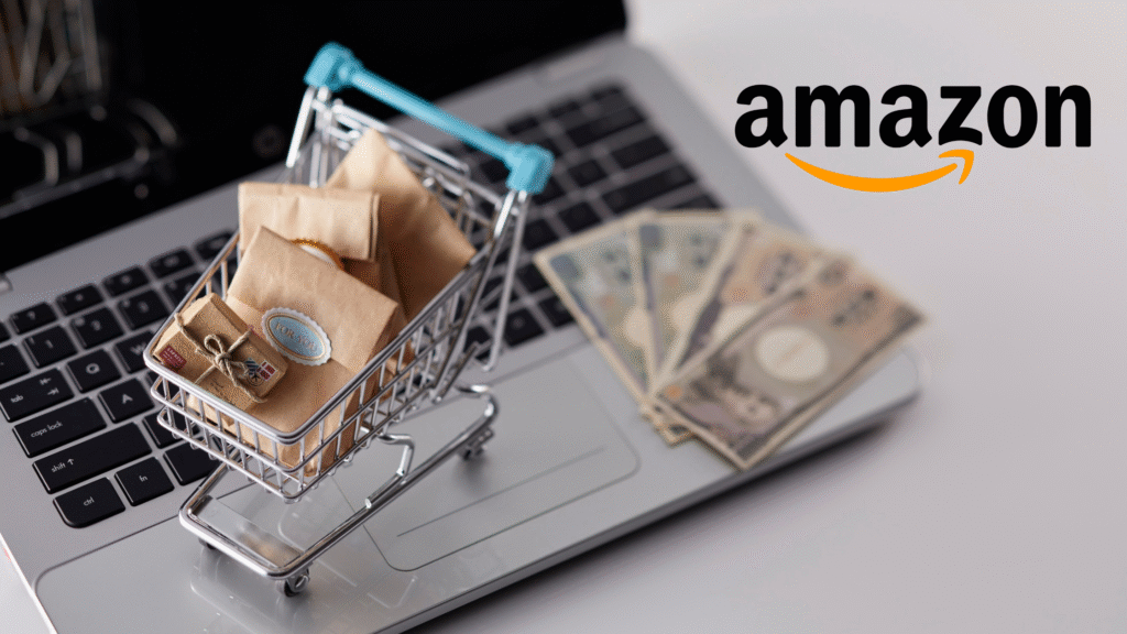 A miniature shopping cart filled with small brown parcels sits on the keyboard of a laptop, next to a fan of Japanese yen banknotes, with the Amazon logo floating above.